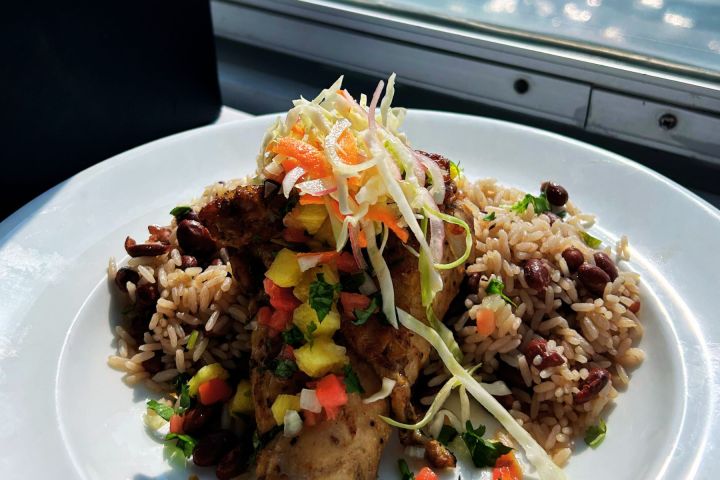 a plate of food with rice meat and vegetables