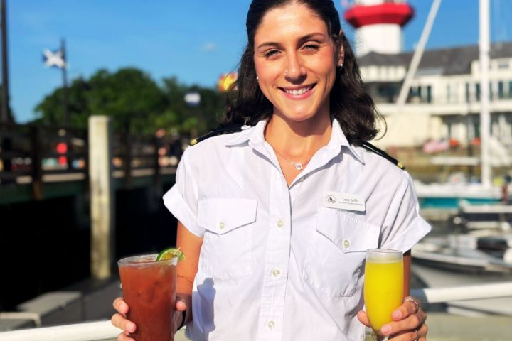 a person drinking a glass of orange juice